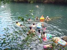 A large rock provides a foothold in the water